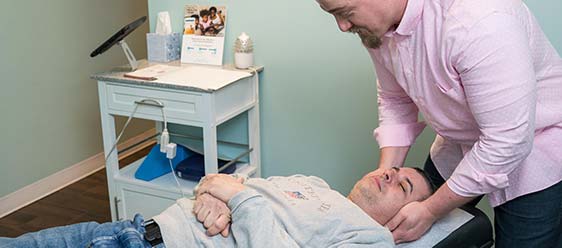 Chiropractor West Hartford CT Dr. Mitchell Graham Adjusting Patient